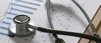 Graphs and stethoscope stock image.